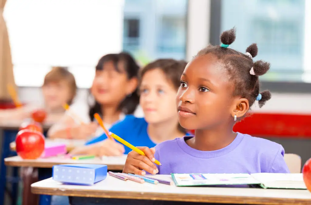 A child sitting at their desk in school.